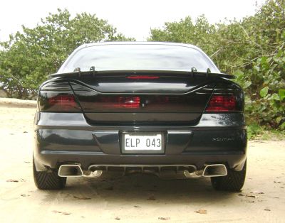 rear view
The tails where painted with clear coat paint & a little of black tint added to it. then it was buffed, polished, & waxed like you would on a paint-job. they shine better than when new. The spoiler & ground effect where hand made by me. 
