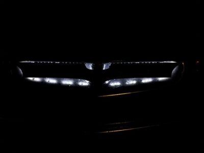 my custom grille piece :) 
26 inches across and 4 1/2 inches high..mounted with two bolts and drilled thru the old emblem location.
Keywords: custom grille lighting black bonneville batman